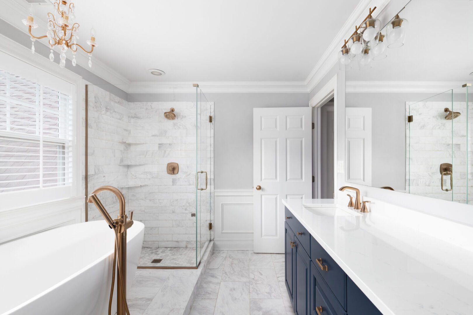 Luxurious white bathroom with gold fixtures.