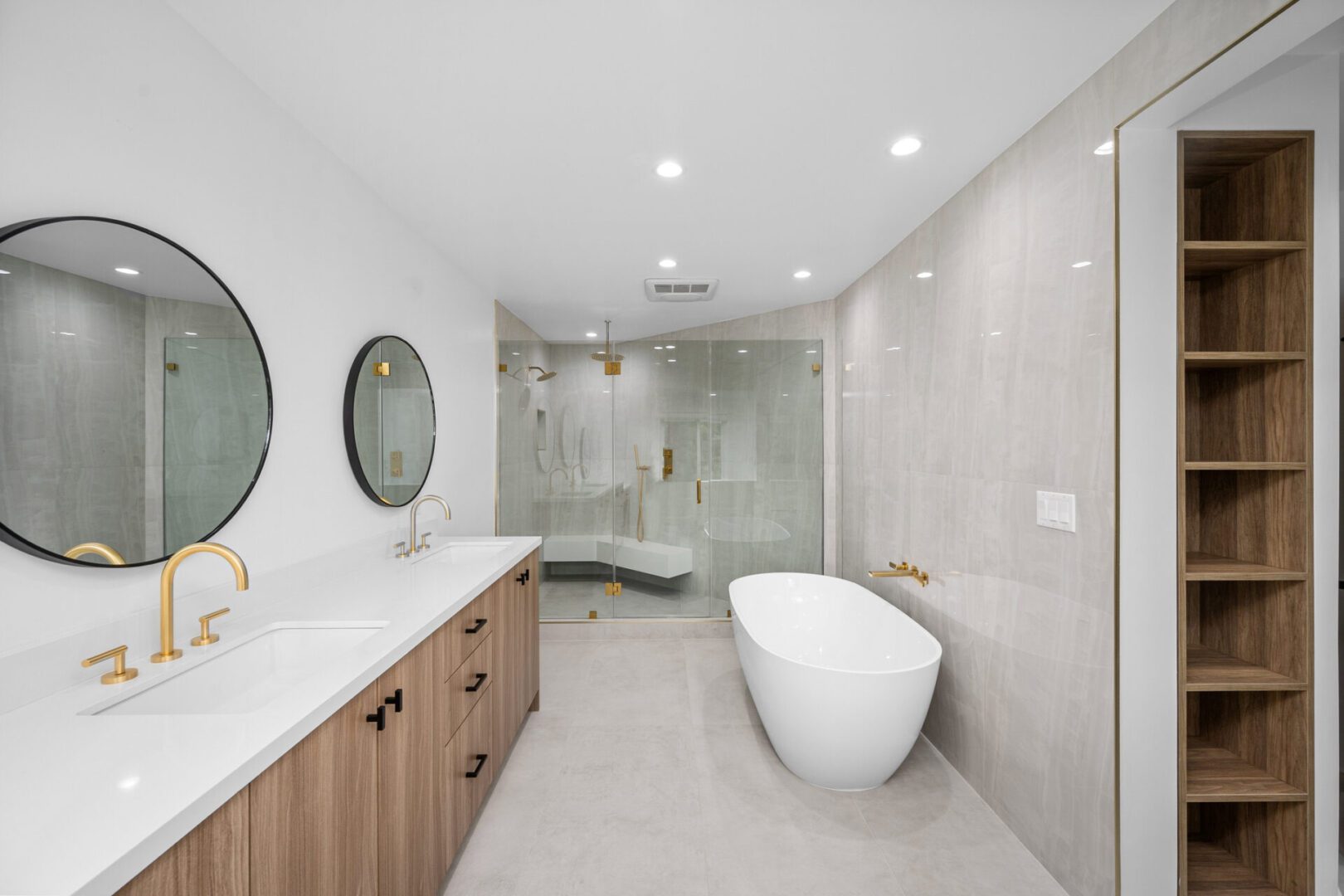 Modern bathroom with freestanding bathtub and mirrors.