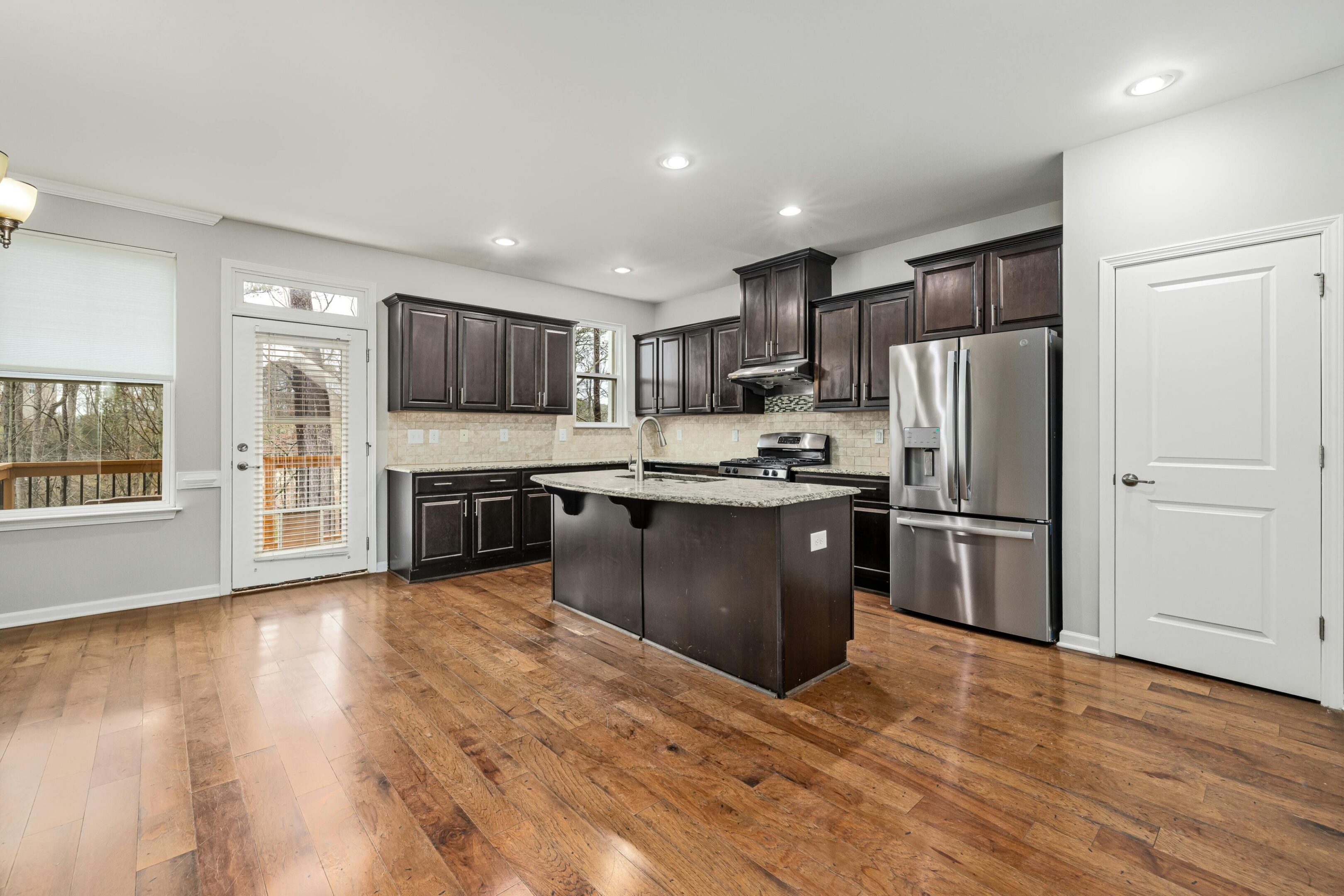 Modern kitchen with dark cabinets and island.