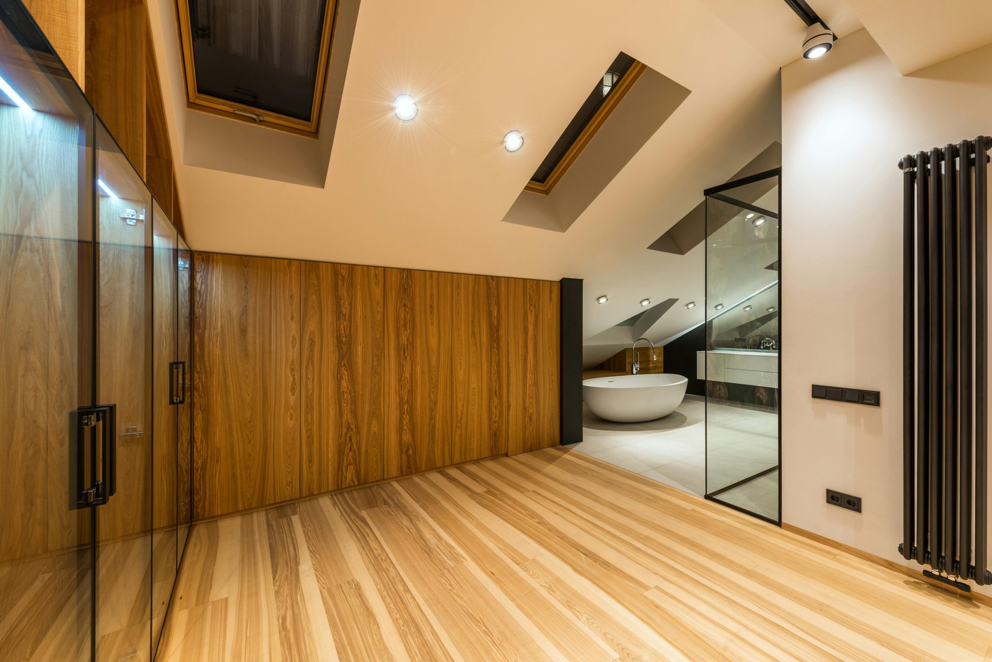 Modern attic bathroom with wooden accents.