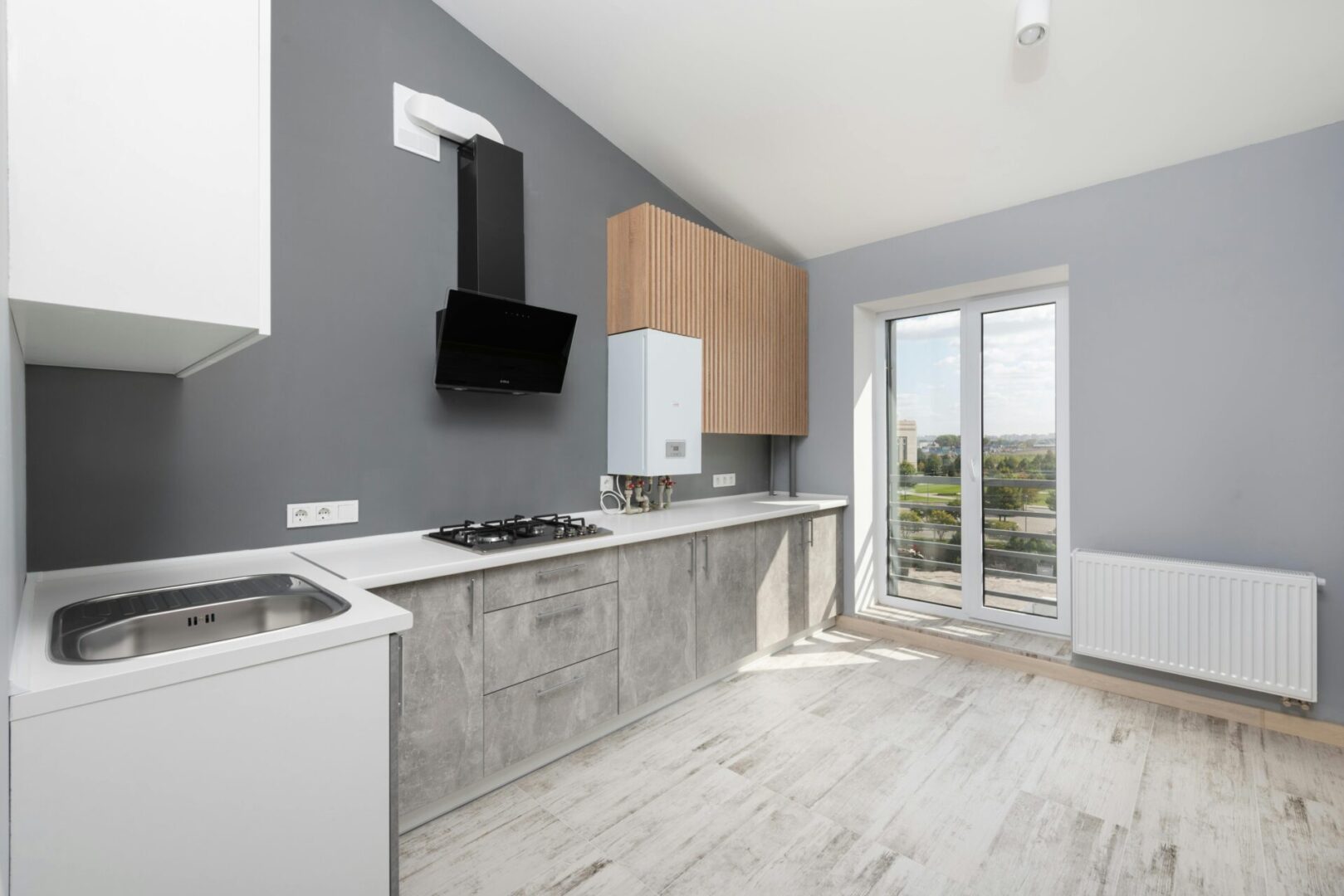 Modern kitchen with gray and white decor.